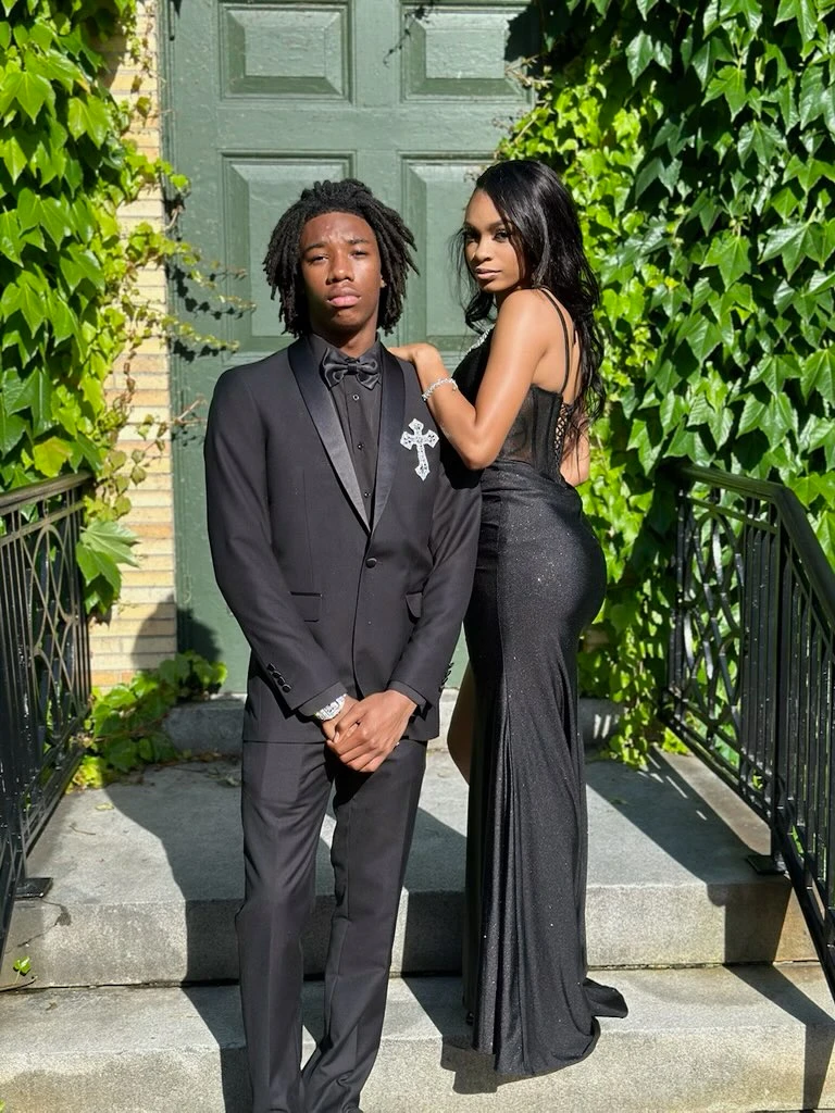 Prom couple in sleek black formal attire
