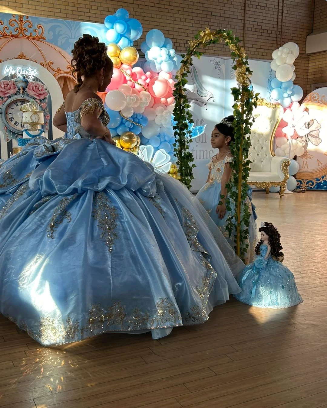 Quinceañera princess in blue ball gown at celebration venue