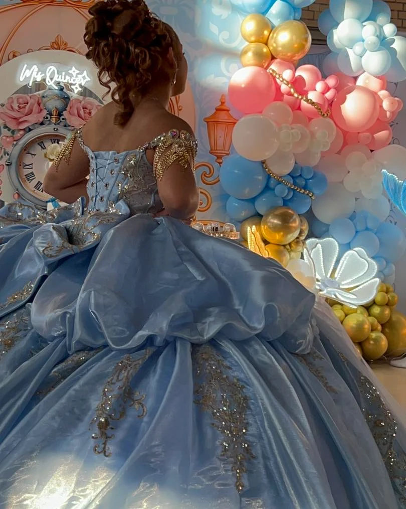 Stunning blue quinceañera gown with gold embroidery details