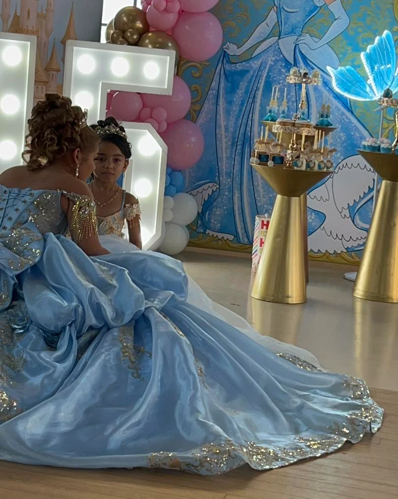 Quinceañera Cinderella moment in blue gown with flower girl