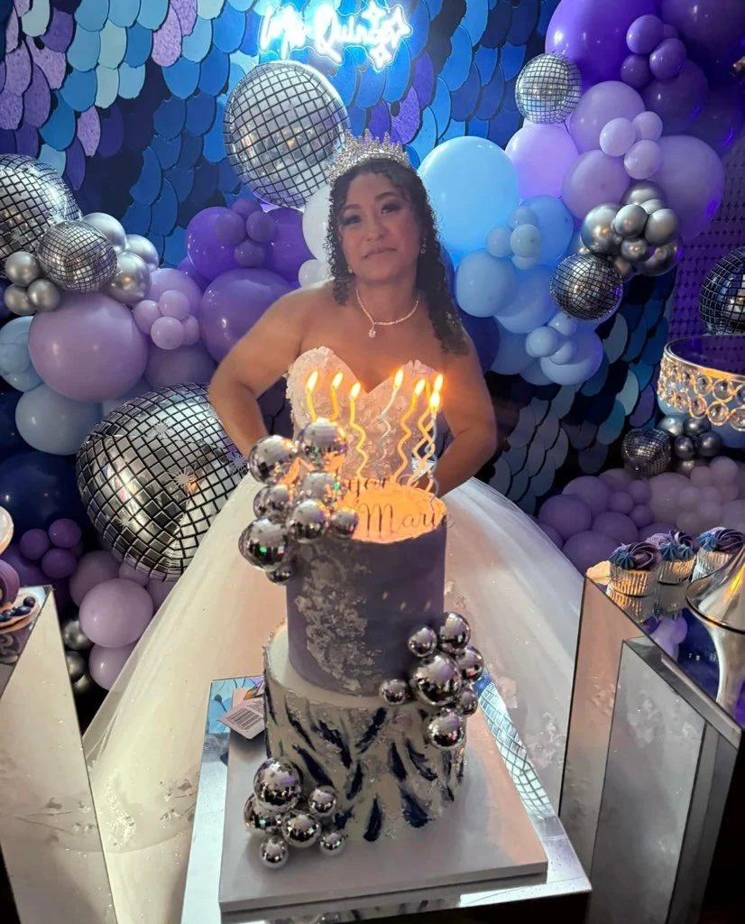 Quinceañera birthday cake moment with purple and silver decor
