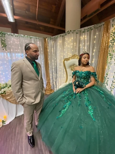 Quinceañera princess in emerald green ball gown with tiara