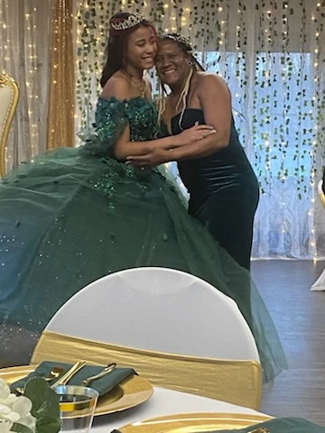Shannette with quinceañera client in emerald green gown