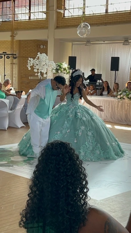Quinceañera first dance in mint green ball gown