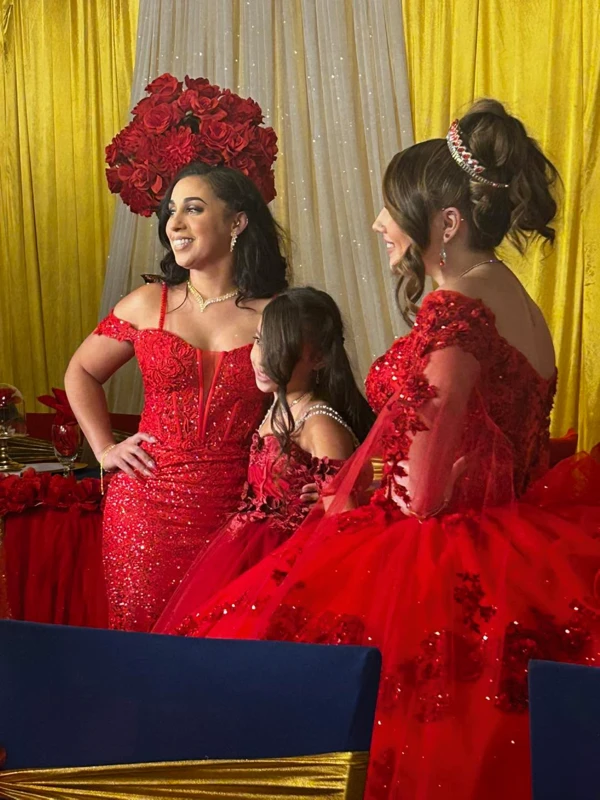 Quinceañera with stunning red gowns and matching flower girl dresses