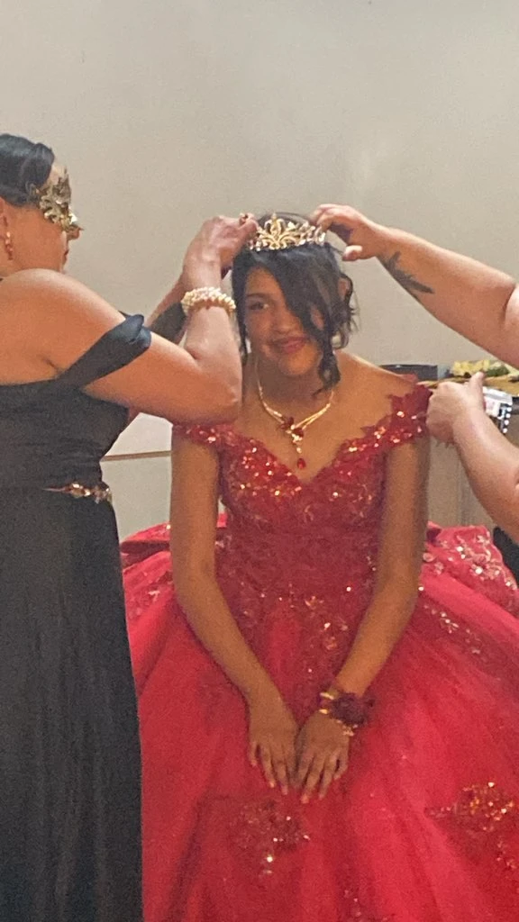 Quinceañera tiara crowning moment in red gown